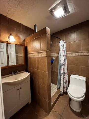 a bathroom with a toilet sink and shower