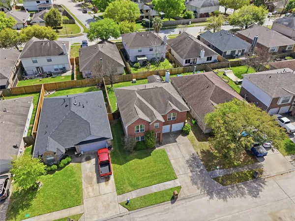 an aerial view of multiple houses with yard
