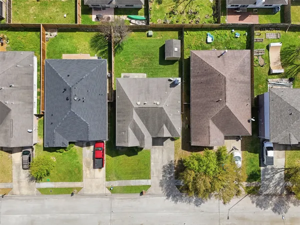 an aerial view of multiple houses with a yard