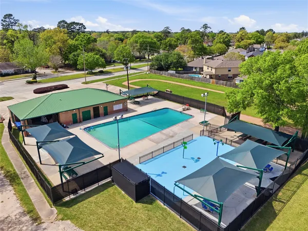 an aerial view of a house with swimming pool patio and outdoor seating