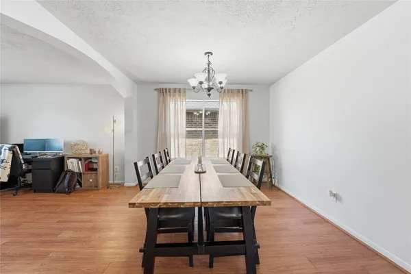 a dining room with furniture window and wooden floor