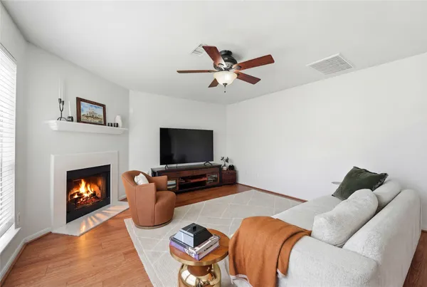a living room with furniture a flat screen tv and a fireplace