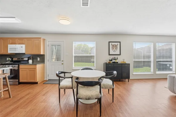 a view of a dining room with furniture and wooden floor