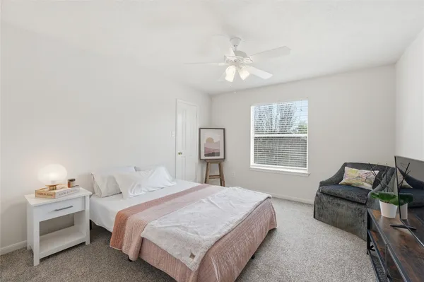 a bedroom with bed and window
