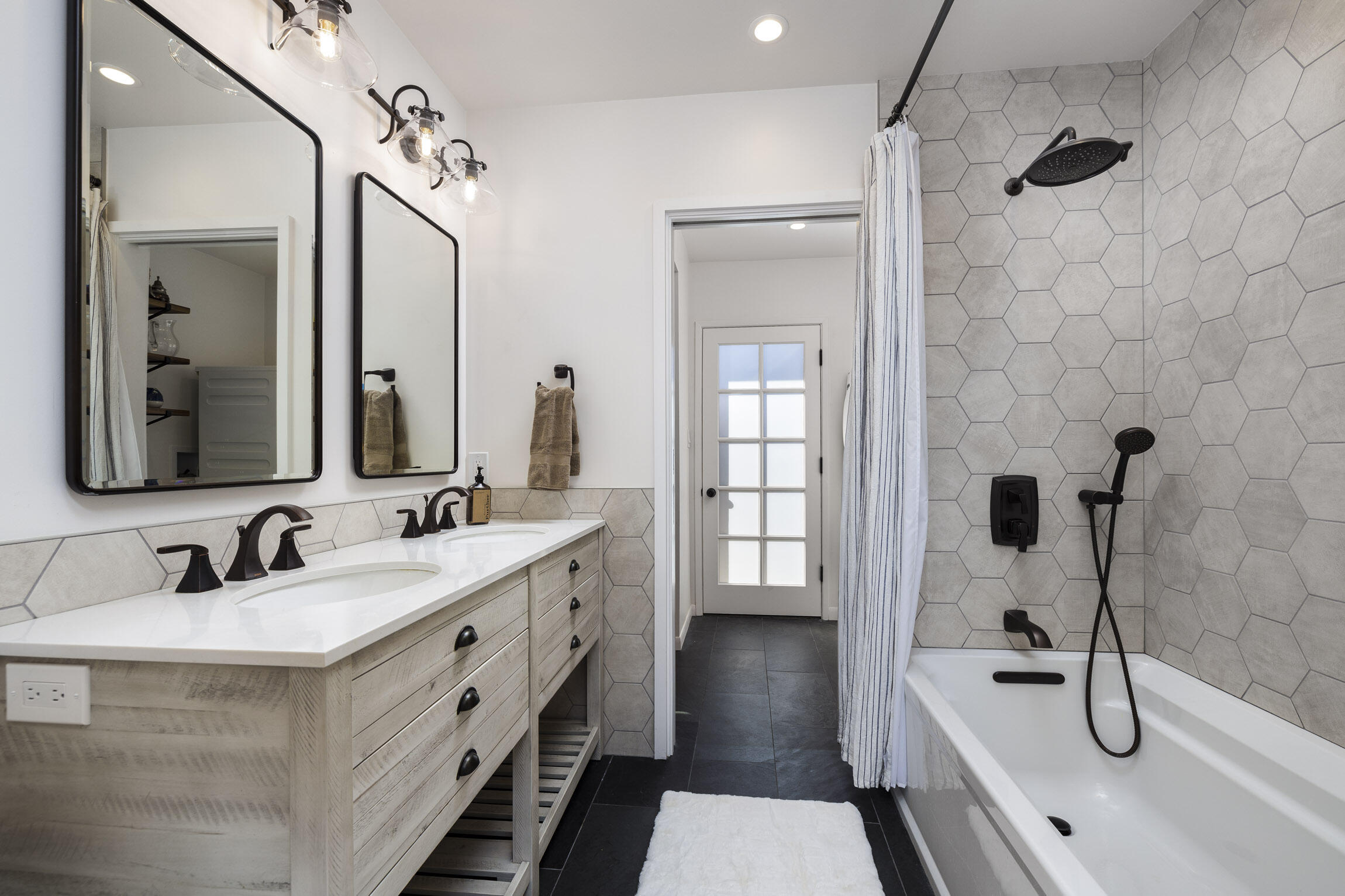 959 Barcelona Drive Santa Barbara, CA 93105 - Photo 23 of 24 a bathroom with a double vanity sink a mirror and a shower