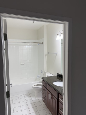 625 Deerfield Road, Unit 321 Deerfield, IL 60015 - Photo 6 of 8 a bathroom with a granite countertop sink a toilet and shower