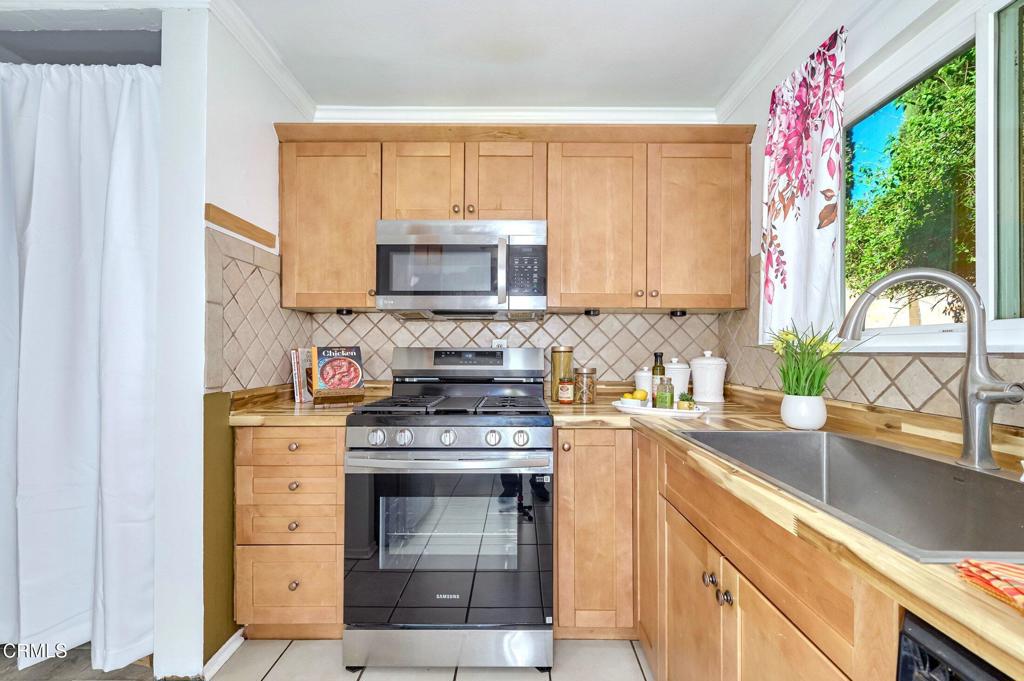 4895 Muirwood Court Simi Valley, CA 93063 - Photo 13 of 45 a kitchen with a stove a sink and a microwave