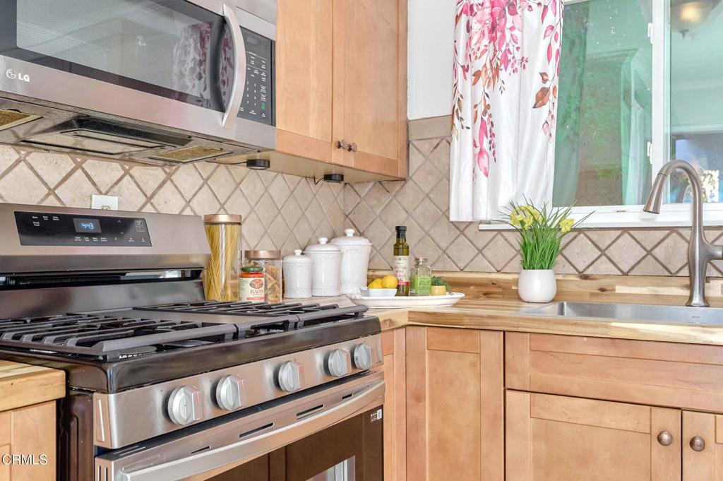4895 Muirwood Court Simi Valley, CA 93063 - Photo 14 of 45 a kitchen with stainless steel appliances granite countertop a sink a stove and a microwave