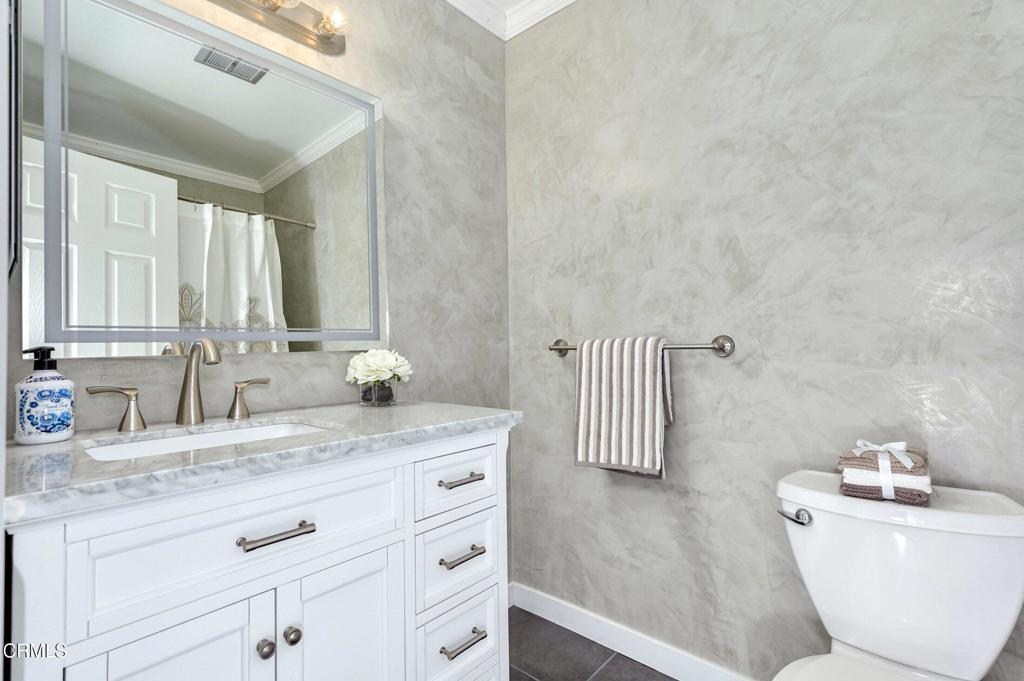4895 Muirwood Court Simi Valley, CA 93063 - Photo 17 of 45 a bathroom with a granite countertop sink mirror vanity and toilet
