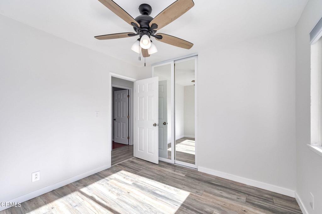 4895 Muirwood Court Simi Valley, CA 93063 - Photo 27 of 45 a view of a hallway with a chandelier fan and wooden floor