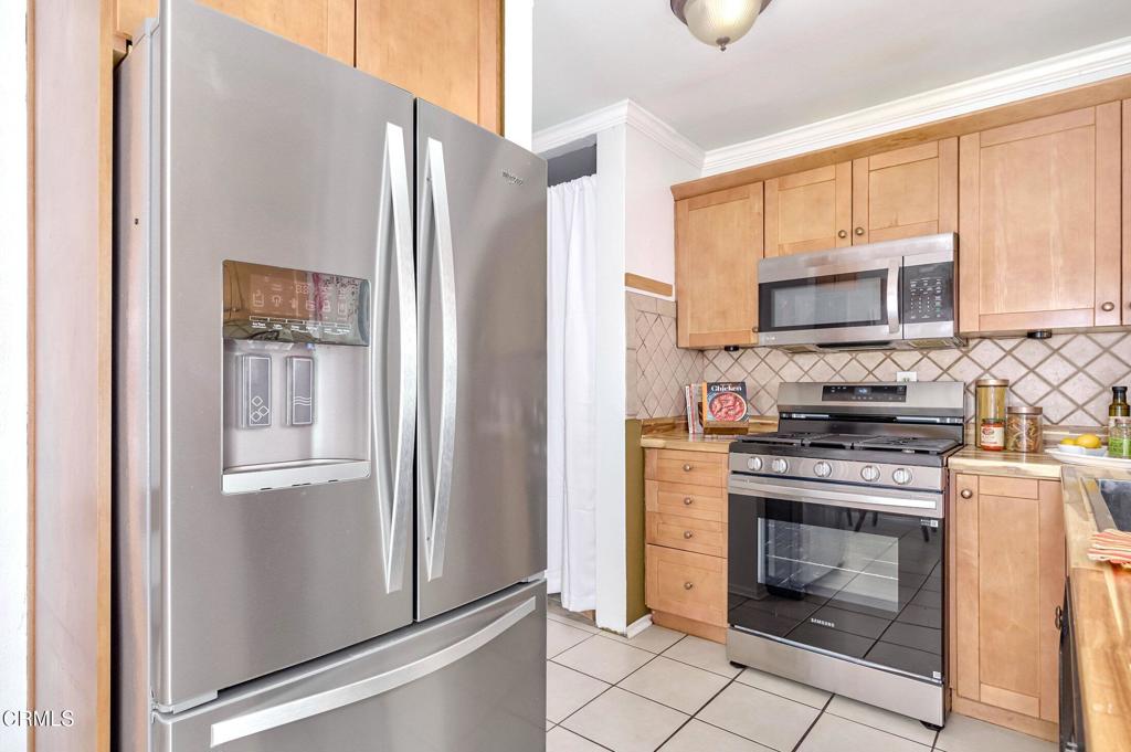 4895 Muirwood Court Simi Valley, CA 93063 - Photo 10 of 45 a kitchen with stainless steel appliances granite countertop a refrigerator and a stove top oven