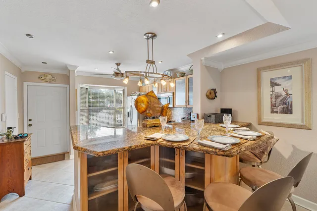 a view of a dining room with furniture wooden floor and chandelier