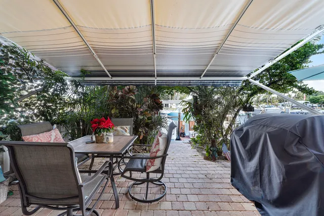 a view of a patio with table and chairs and potted plants