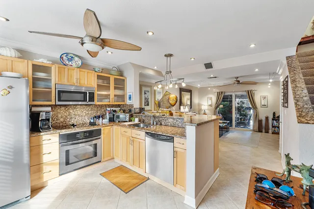 a kitchen with stainless steel appliances granite countertop a stove and cabinets