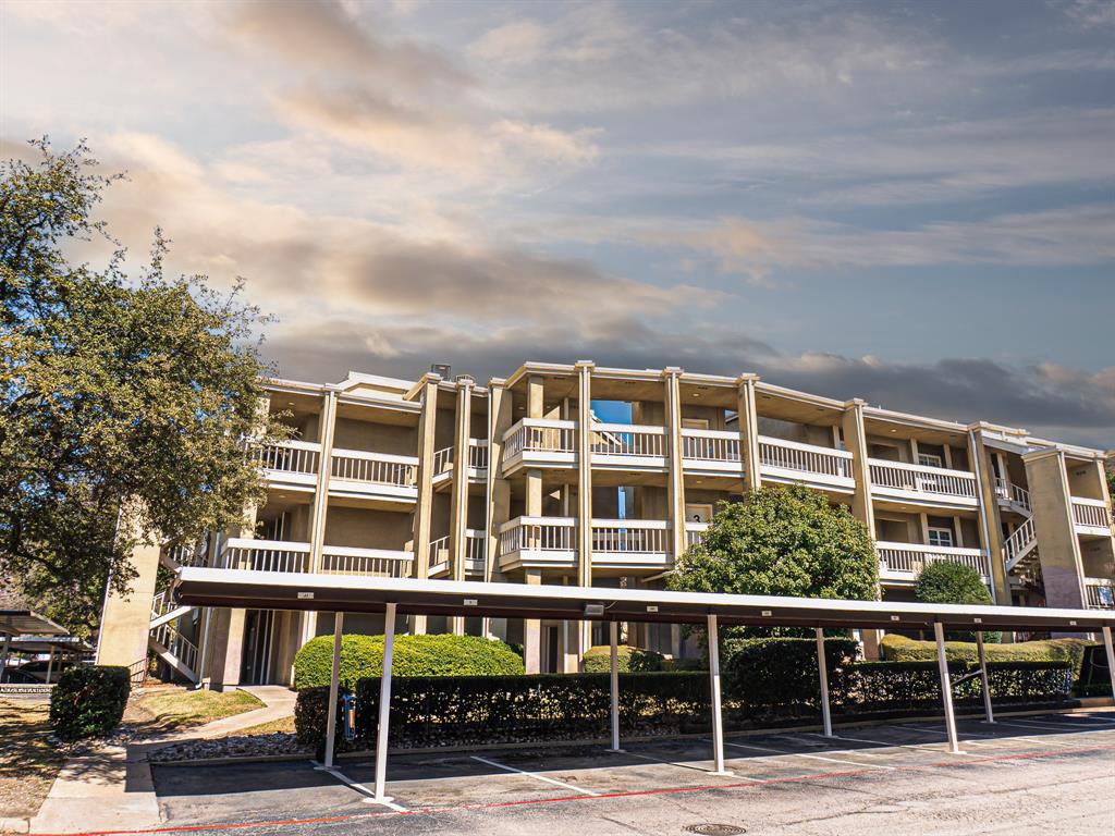 5310 Keller Springs Road, Unit 711 Dallas, TX 75248 - Photo 1 of 20 a view of building with lot of windows