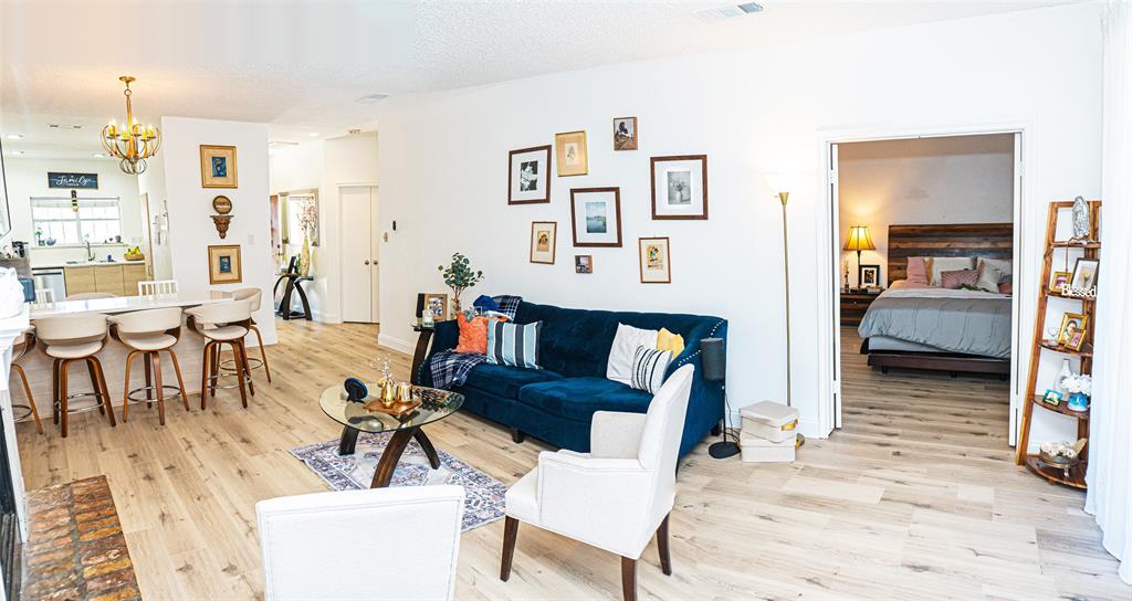 5310 Keller Springs Road, Unit 711 Dallas, TX 75248 - Photo 12 of 20 a living room with furniture and a wooden floor
