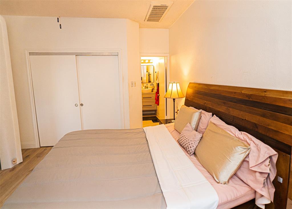 5310 Keller Springs Road, Unit 711 Dallas, TX 75248 - Photo 13 of 20 a bedroom with a bed and a night stand