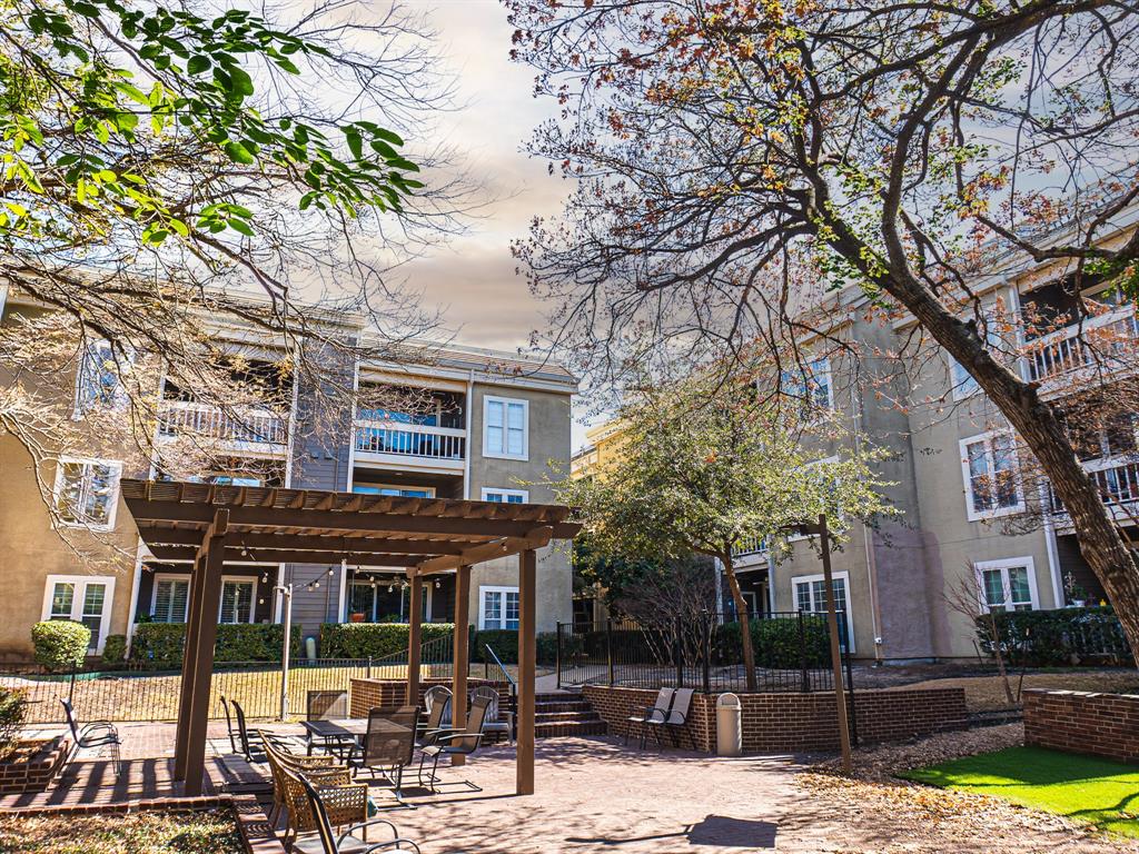 5310 Keller Springs Road, Unit 711 Dallas, TX 75248 - Photo 20 of 20 a view of a building with a yard and sitting area
