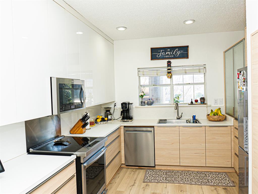 5310 Keller Springs Road, Unit 711 Dallas, TX 75248 - Photo 6 of 20 a kitchen with a sink and a stove top oven
