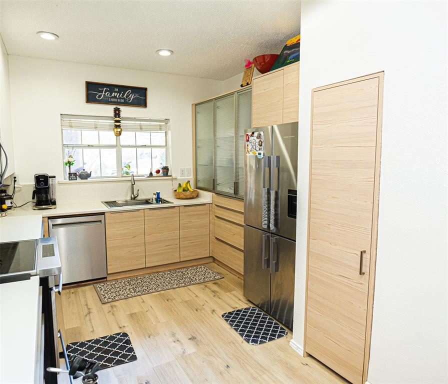 5310 Keller Springs Road, Unit 711 Dallas, TX 75248 - Photo 7 of 20 a kitchen with a refrigerator and white cabinets