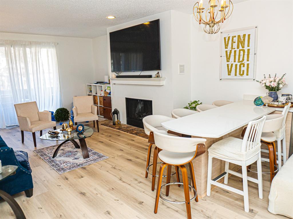 5310 Keller Springs Road, Unit 711 Dallas, TX 75248 - Photo 10 of 20 a living room with furniture a flat screen tv and a fireplace