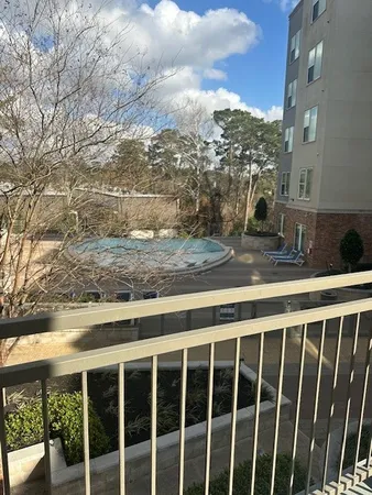 an empty room with chandelier fan and windows