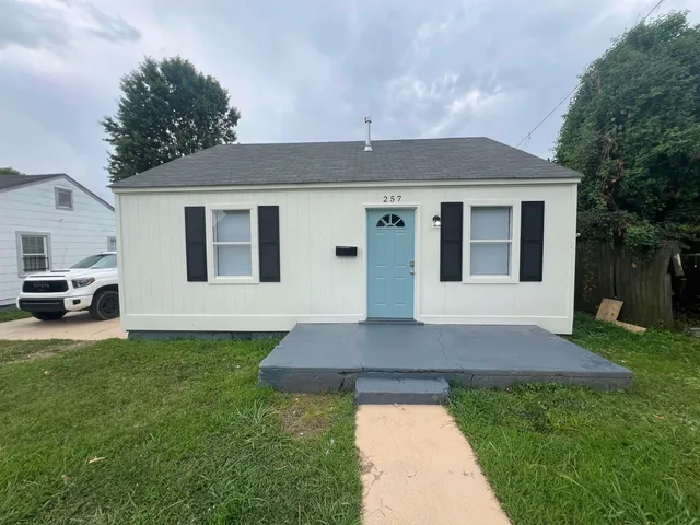 a front view of a house with a yard