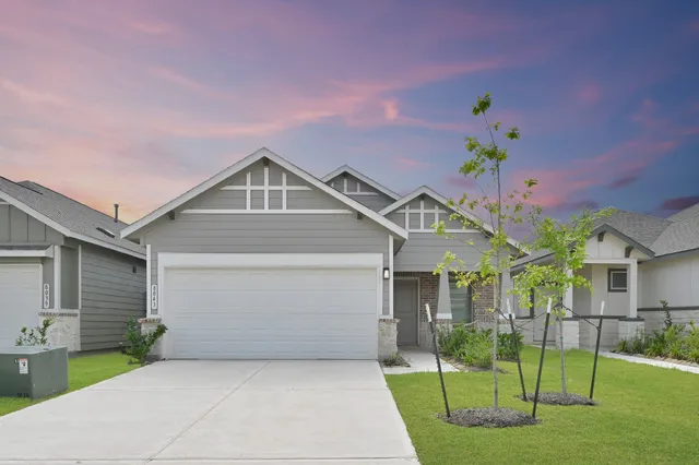 a front view of a house with a yard and porch