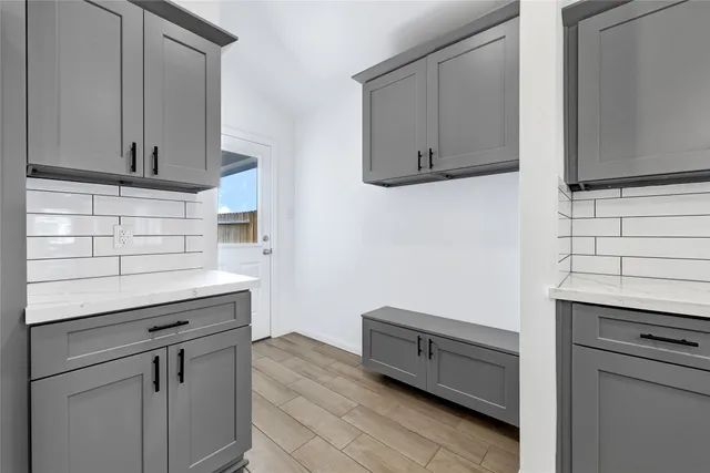 a kitchen with cabinets appliances and a counter space