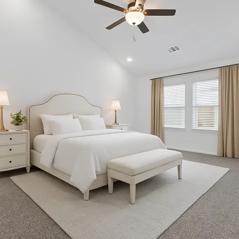 a bedroom with a large bed and a chandelier