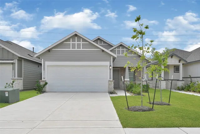 a view of a house with a yard and a garden