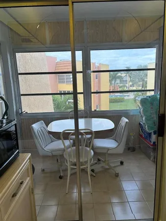 a view of a chairs and table in the balcony