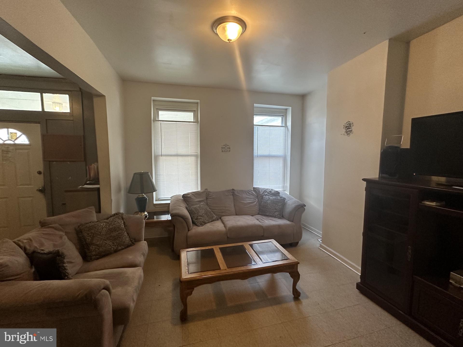 3926 Ridgewood Avenue Baltimore, MD 21215 - Photo 3 of 21 a living room with furniture and a flat screen tv