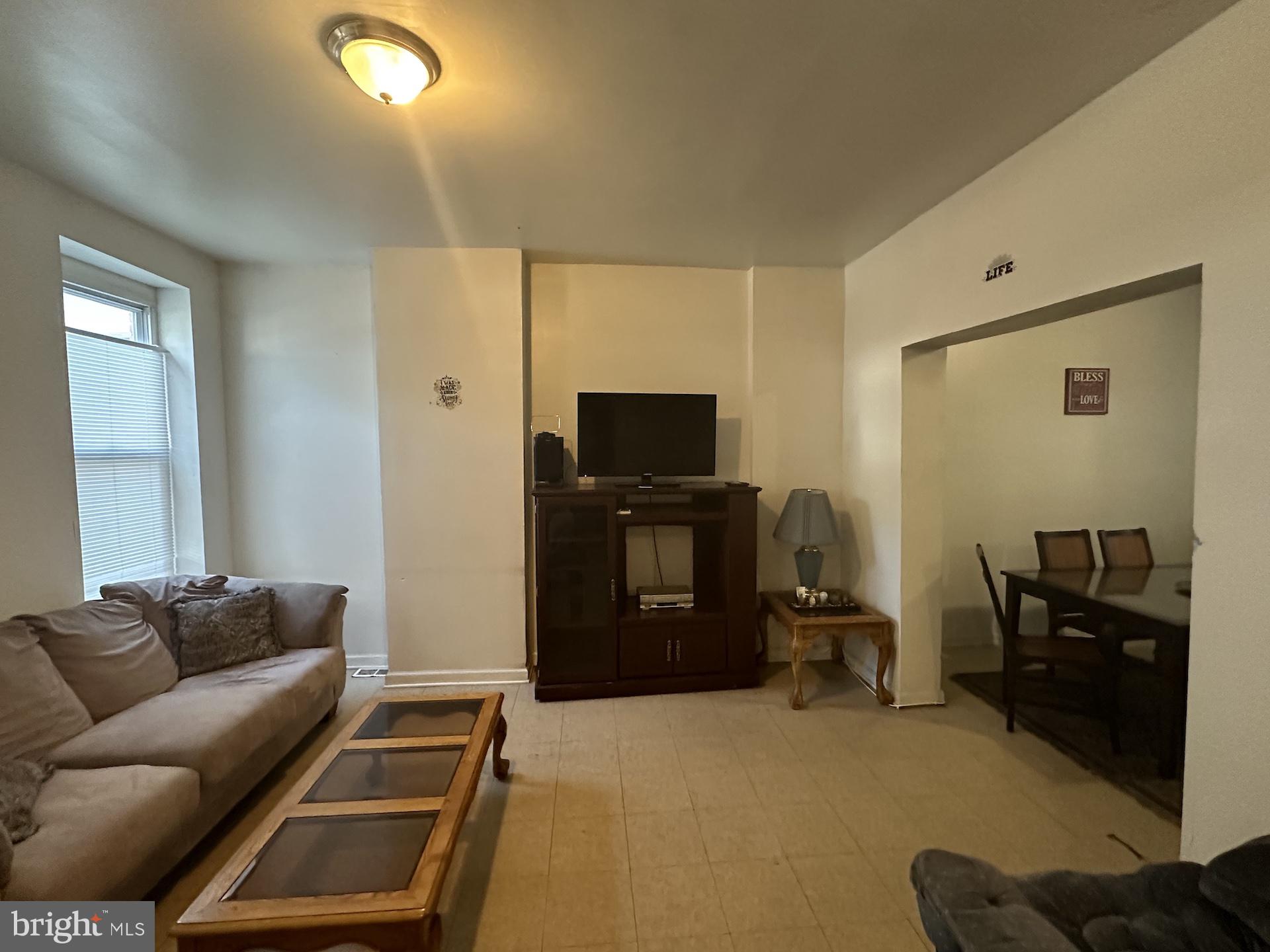 3926 Ridgewood Avenue Baltimore, MD 21215 - Photo 4 of 21 a living room with furniture and a flat screen tv