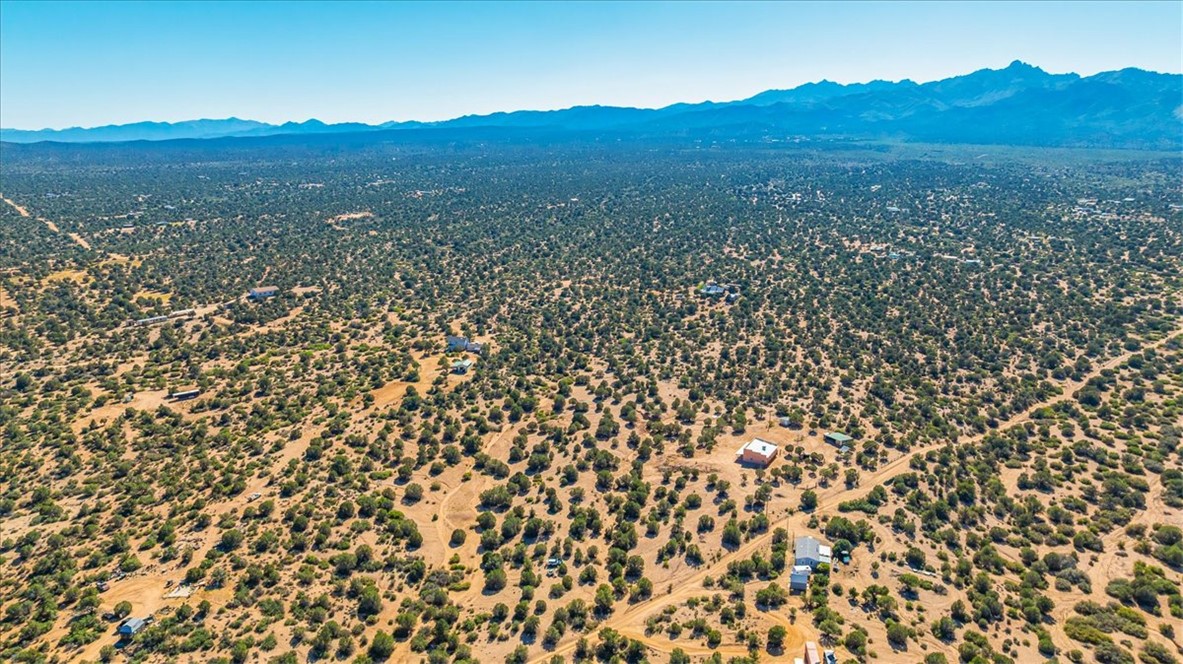 10374 East Happy Trails Road Kingman, AZ 86401 - Photo 64 of 68 a view of a lush green field with mountains in the background
