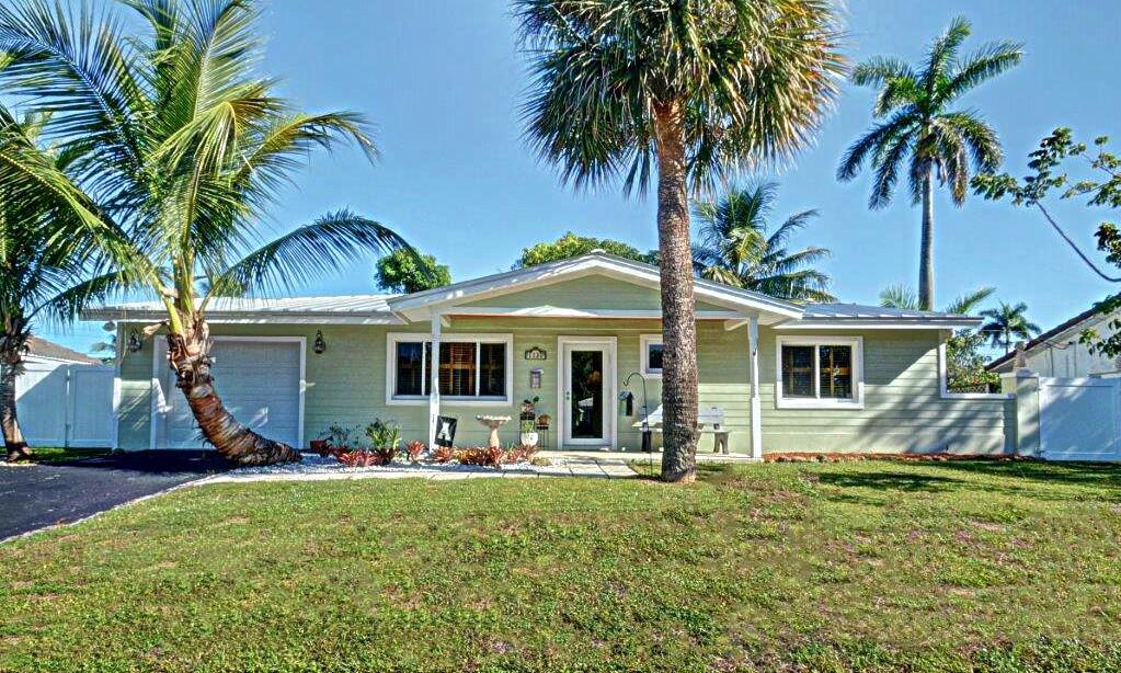 1135 Southwest 14th Street Boca Raton, FL 33486 - Photo 1 of 26 a front view of house with yard and outdoor seating