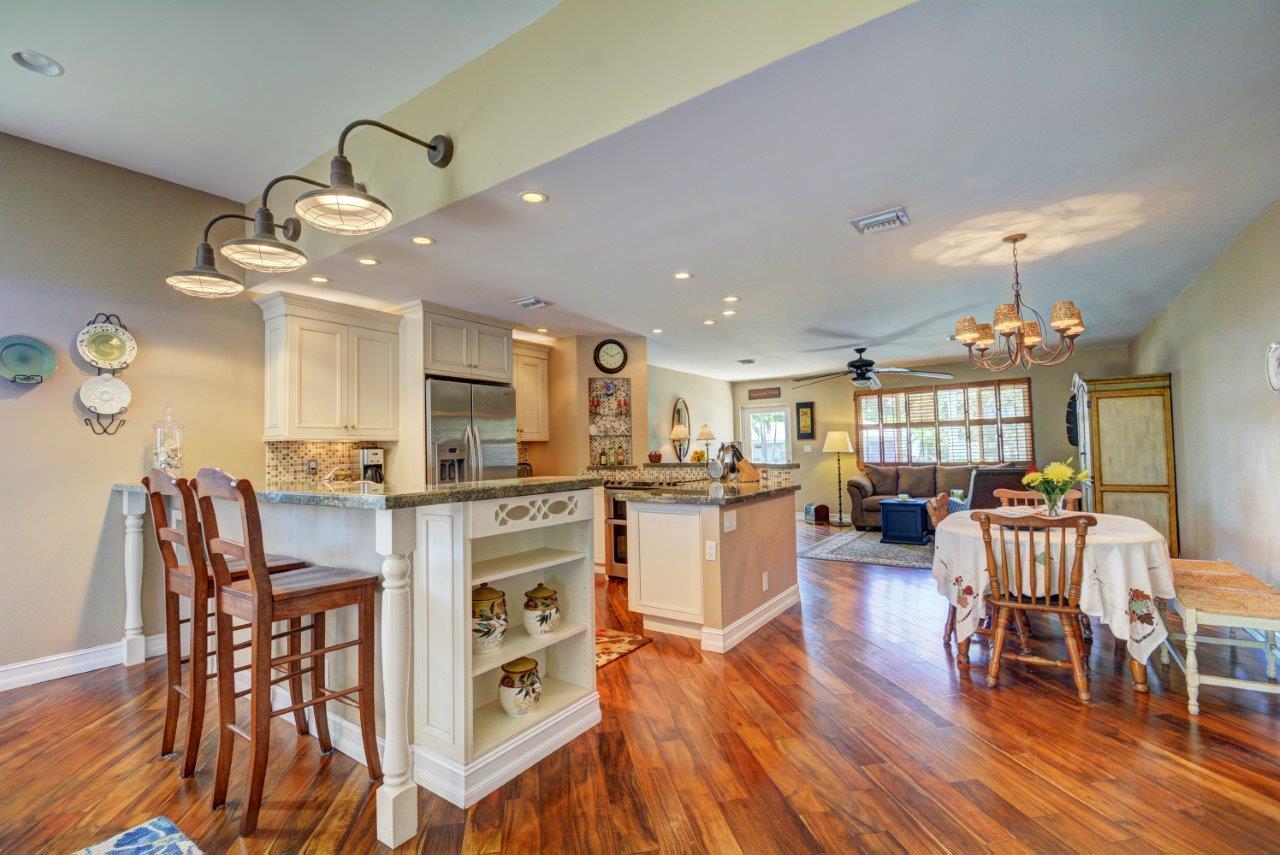 1135 Southwest 14th Street Boca Raton, FL 33486 - Photo 8 of 26 a view of a dining room with furniture and wooden floor