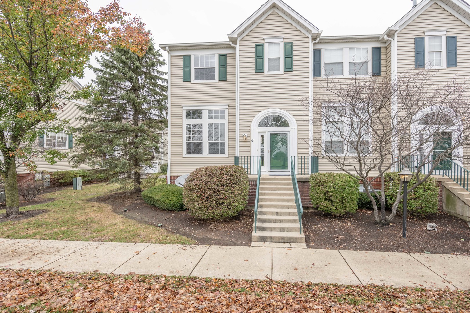 2430 Courtyard Circle, Unit 6 Aurora, IL 60506 - Photo 1 of 28 a front view of a house with a garden