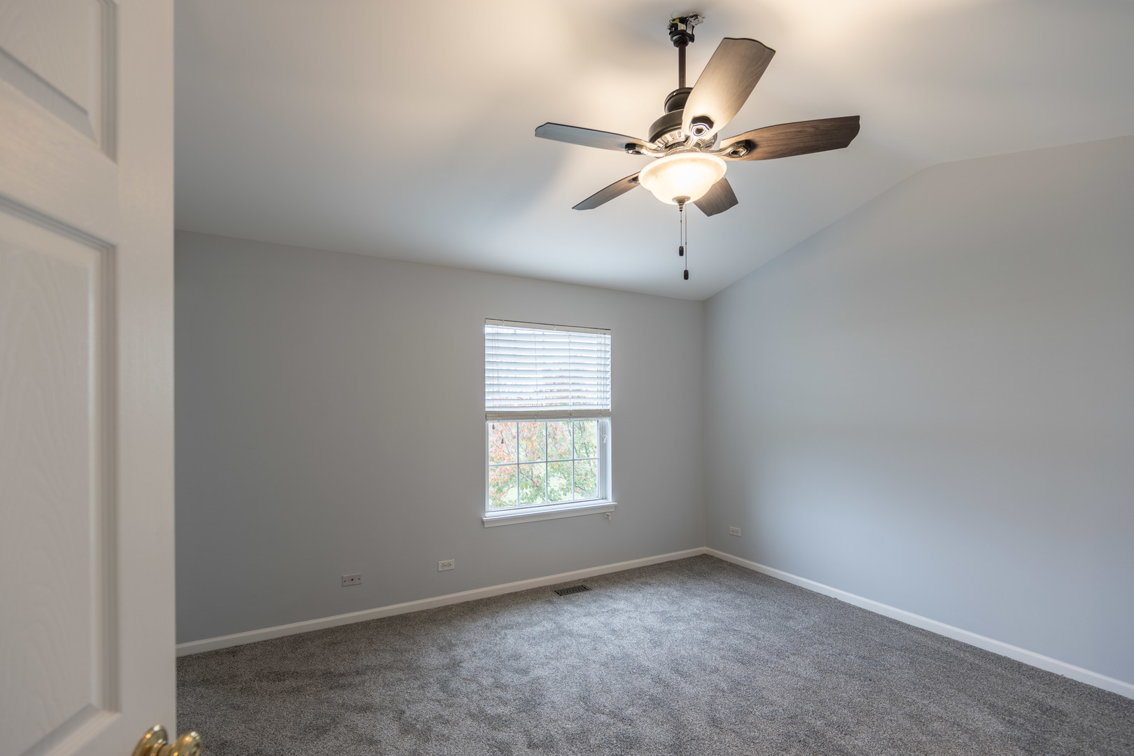 2430 Courtyard Circle, Unit 6 Aurora, IL 60506 - Photo 14 of 28 an empty room with a window and a fan