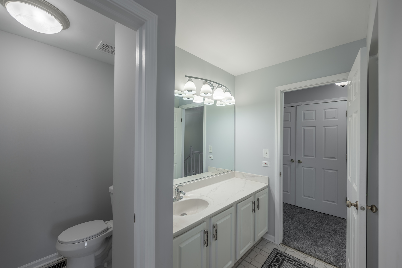 2430 Courtyard Circle, Unit 6 Aurora, IL 60506 - Photo 15 of 28 a bathroom with a granite countertop sink a toilet and shower