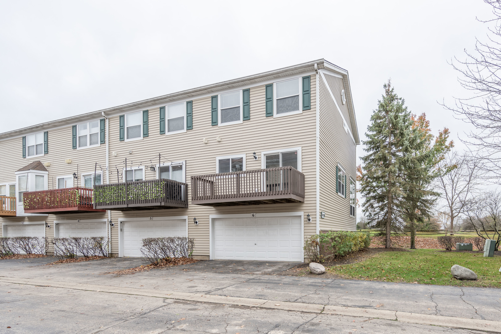 2430 Courtyard Circle, Unit 6 Aurora, IL 60506 - Photo 28 of 28 a front view of a house with a garden and plants