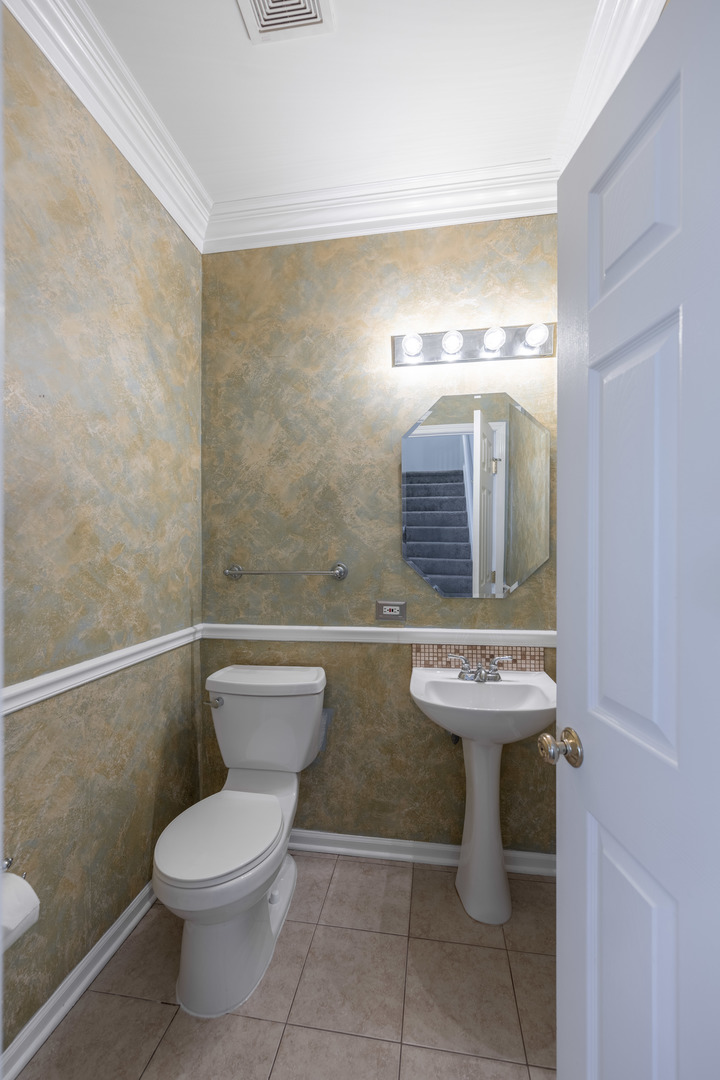 2430 Courtyard Circle, Unit 6 Aurora, IL 60506 - Photo 7 of 28 a bathroom with a toilet sink and mirror