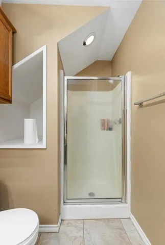 a bathroom with a shower and a toilet