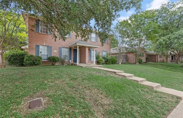 a front view of house with yard and green space