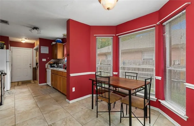 a kitchen with stainless steel appliances kitchen island granite countertop a refrigerator and a stove