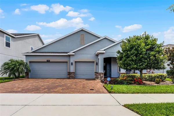 a front view of a house with a yard and a garage