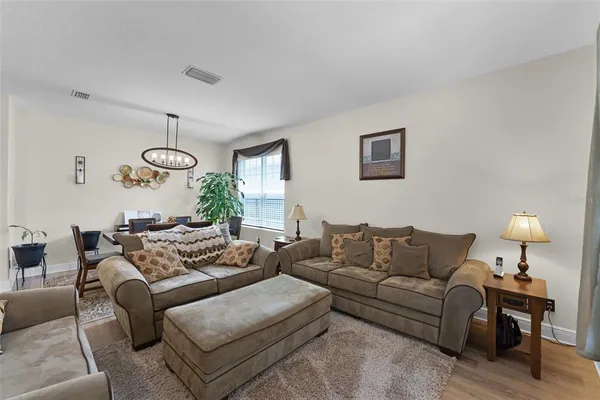 a living room with furniture a window and a table