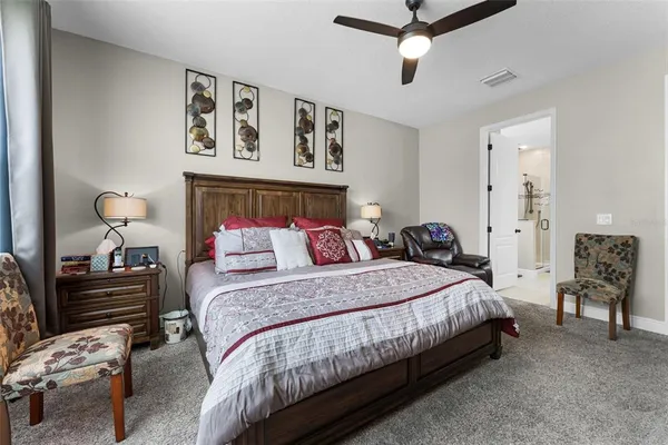 a bedroom with a bed and a mirror