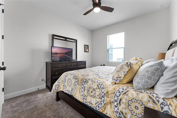 a bedroom with bed and a night stand