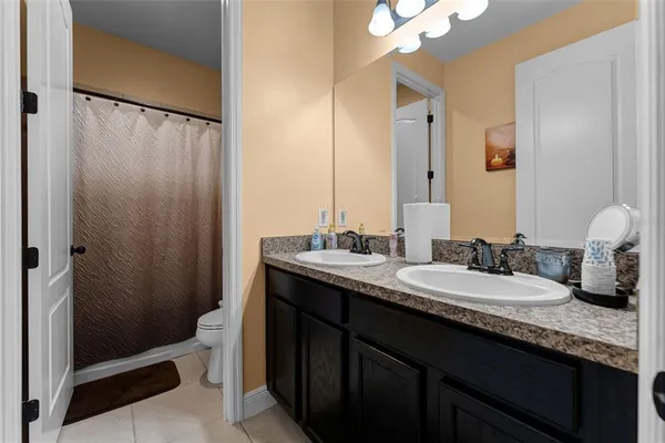 a white toilet sitting next to a shower curtain